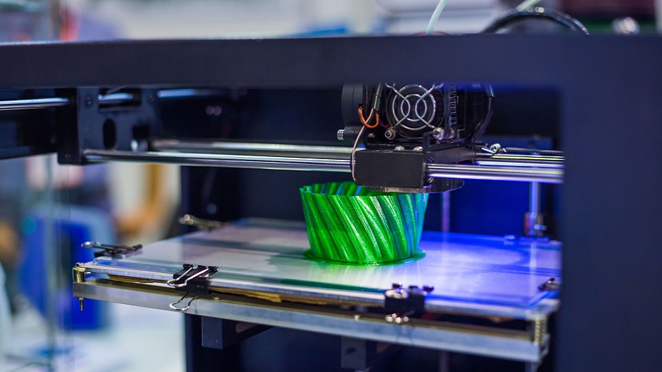 A photo of a plastic bowl being 3D printed
