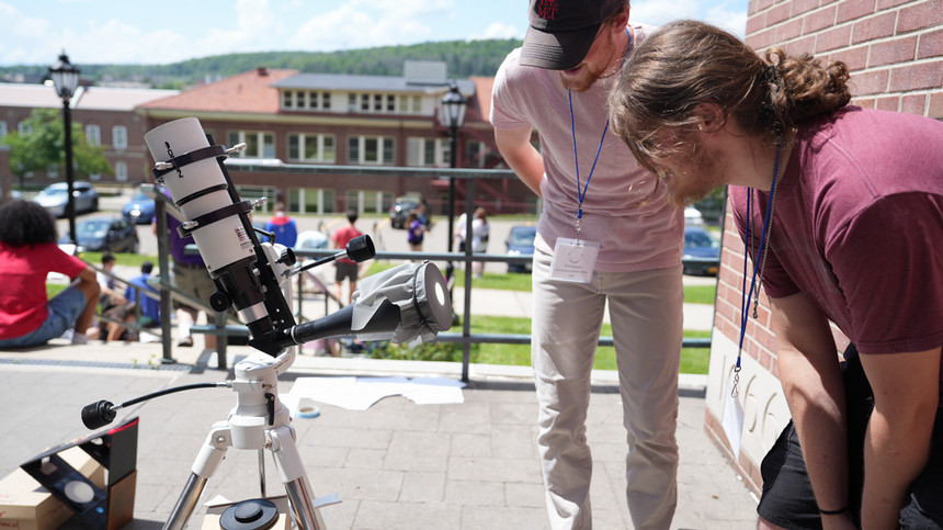 A student looking through a telescope