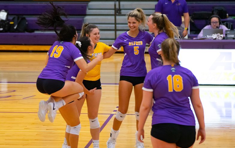 A photo of Alfred University student-athletes celebrating during a game