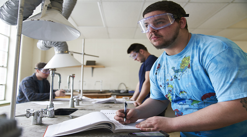A photo of a student working in a science lab