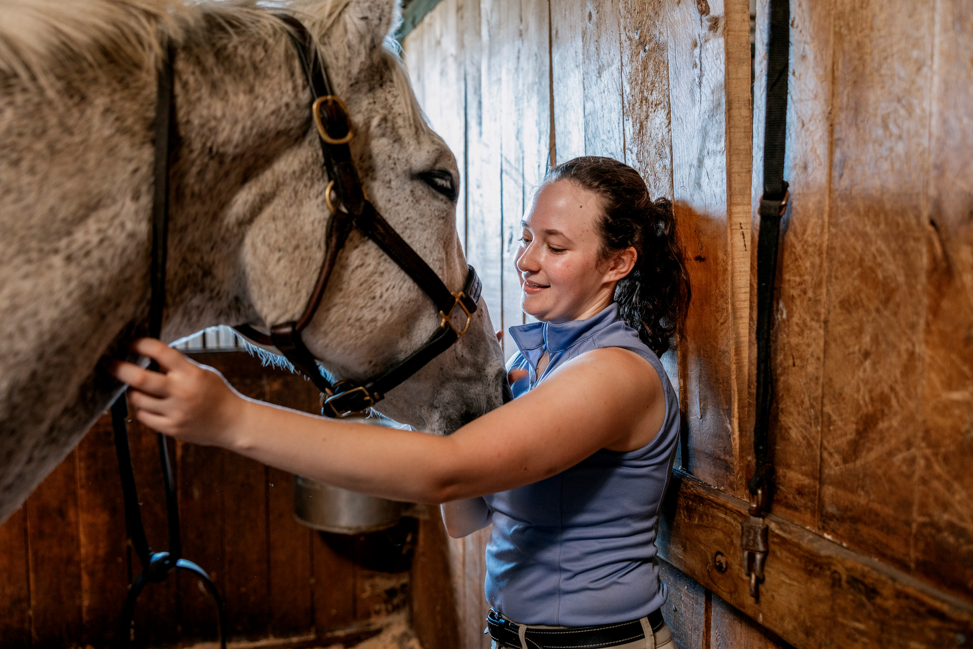 A student petting a horse
