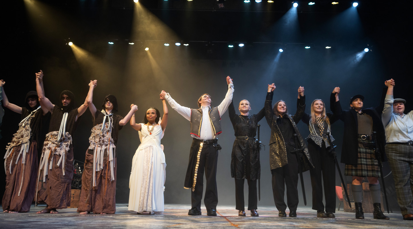 A photo of students taking a bow on stage