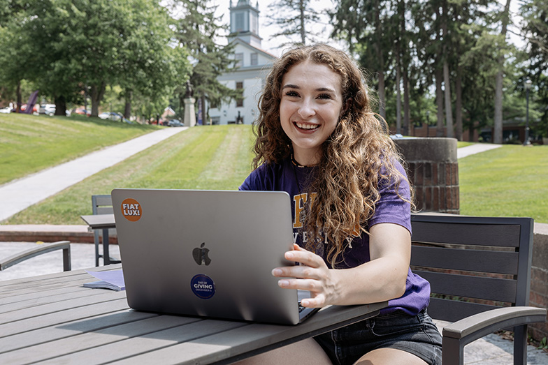 A photo of a student with their laptop