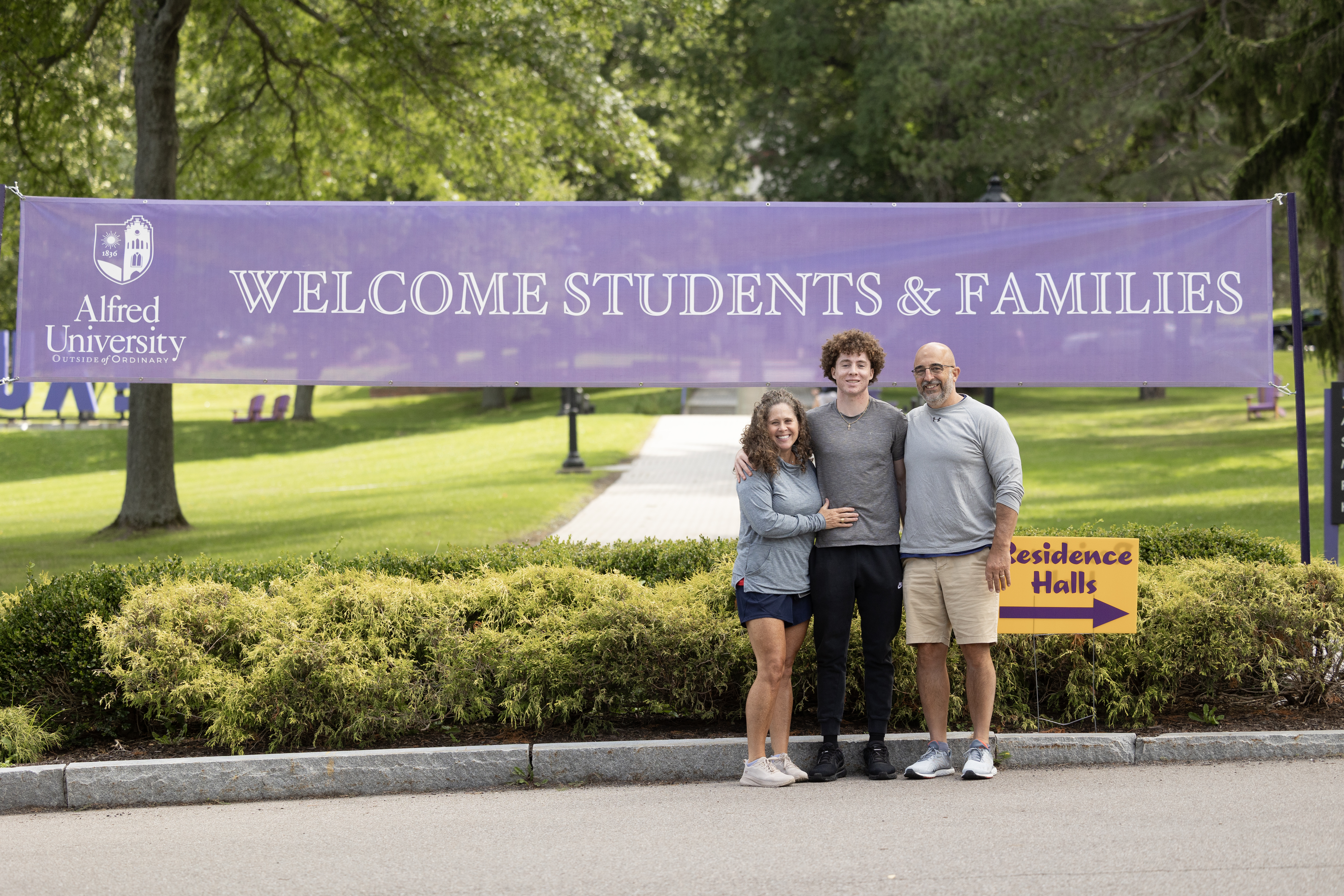 A photo of a student with their parents