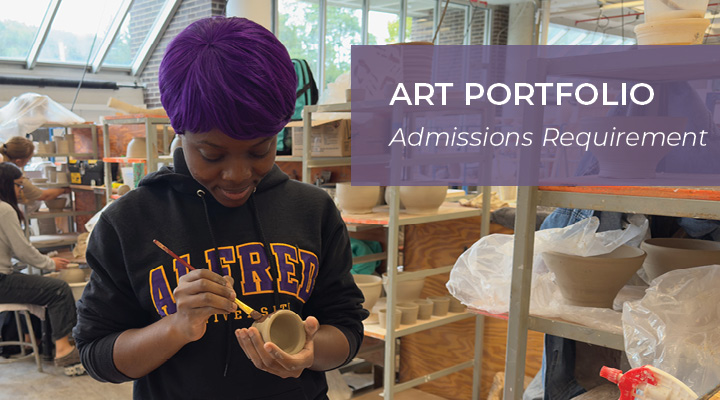 Art student working on a small clay piece in a ceramics studio.