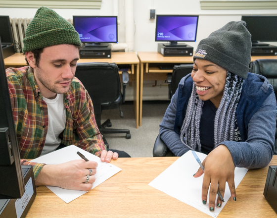 Two students working together in computer lab