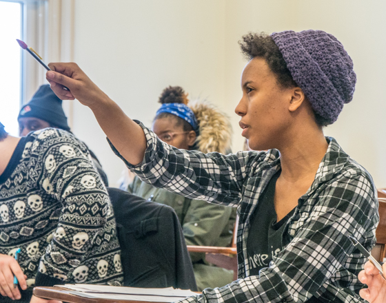 Student raising hand to speak in class