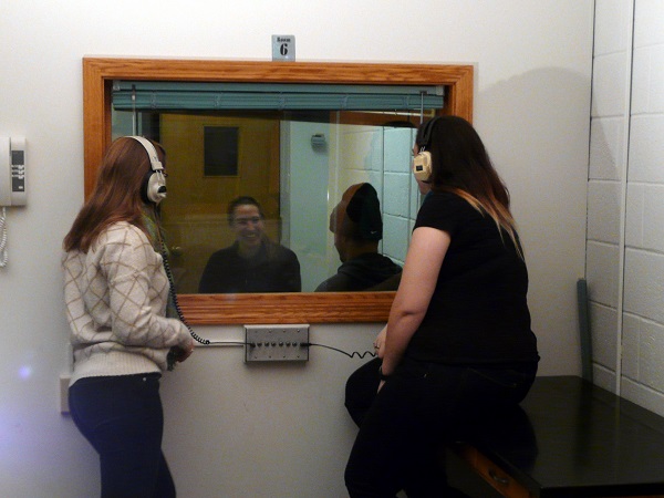 students in another room listening in on a peer counseling session