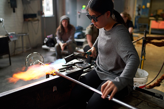 guided campus tour group watching glass blowing