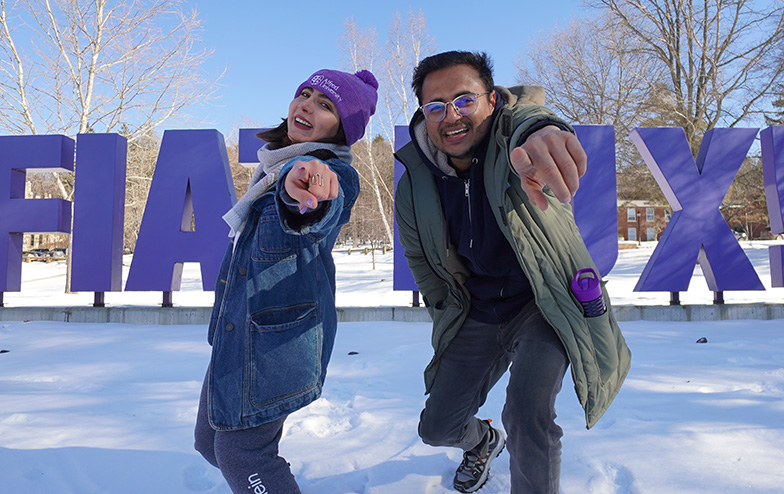 Student sitting in large letters that spell Fiat Luz; cinnamon toast from The Collegiate