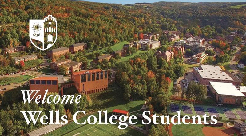 A drone shot of campus with a graphic that says "Welcome Wells Students"