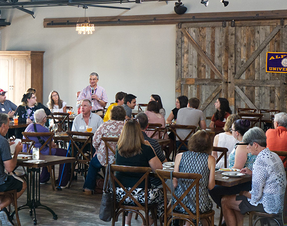 president zupan talking to a group of alumni