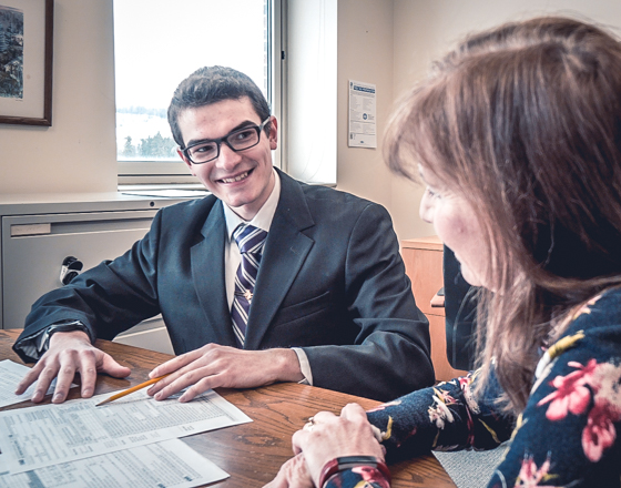 Male student talking with a female faculty member