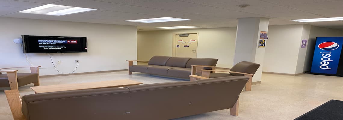 A lounge area equipped with plush couches and a television for relaxation and entertainment.