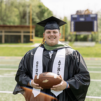 A photo of a student athlete in a cap and gown