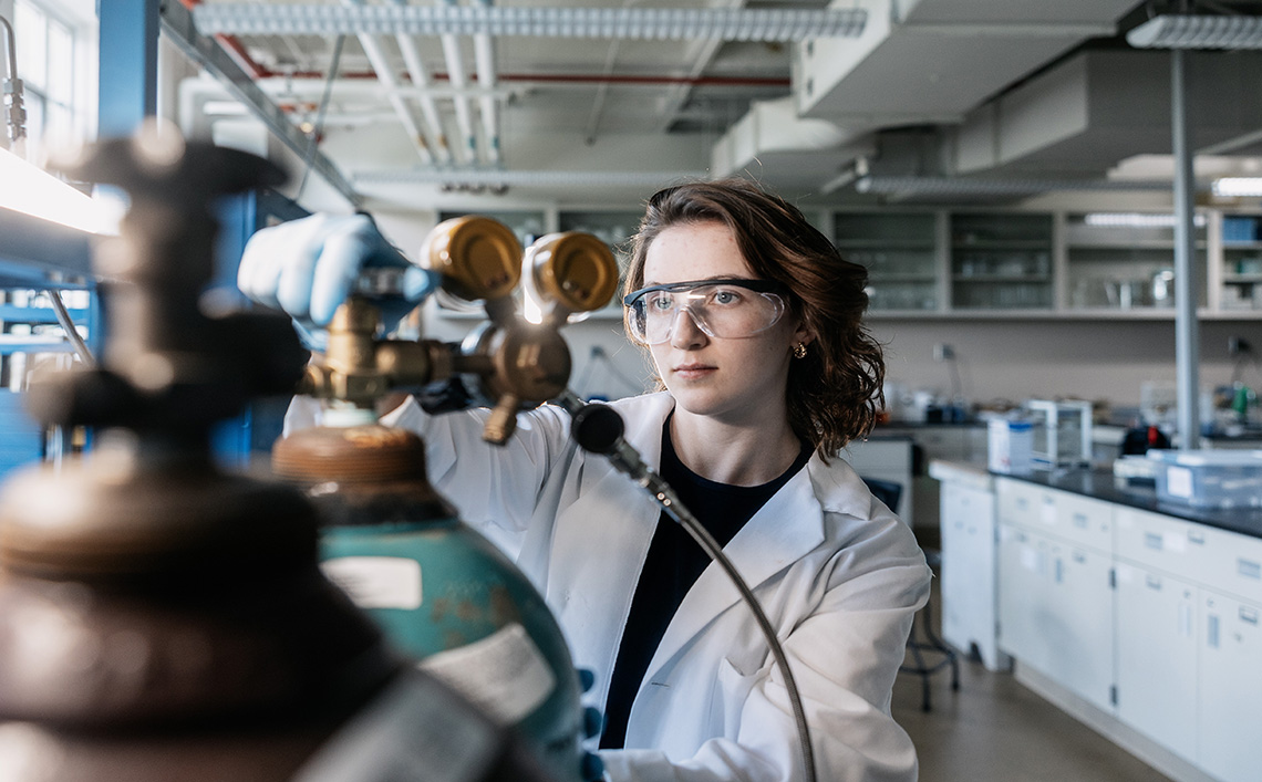 A student using an engineering machine