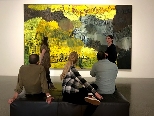 Faculty member and students in a museum