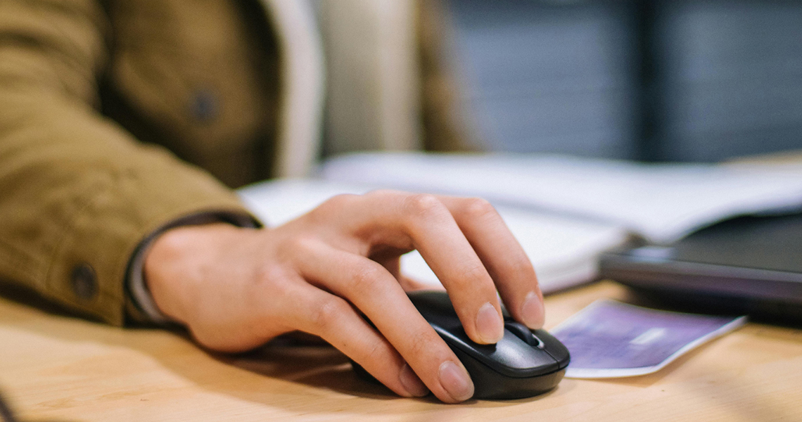 A photo of a hand holding a computer mouse