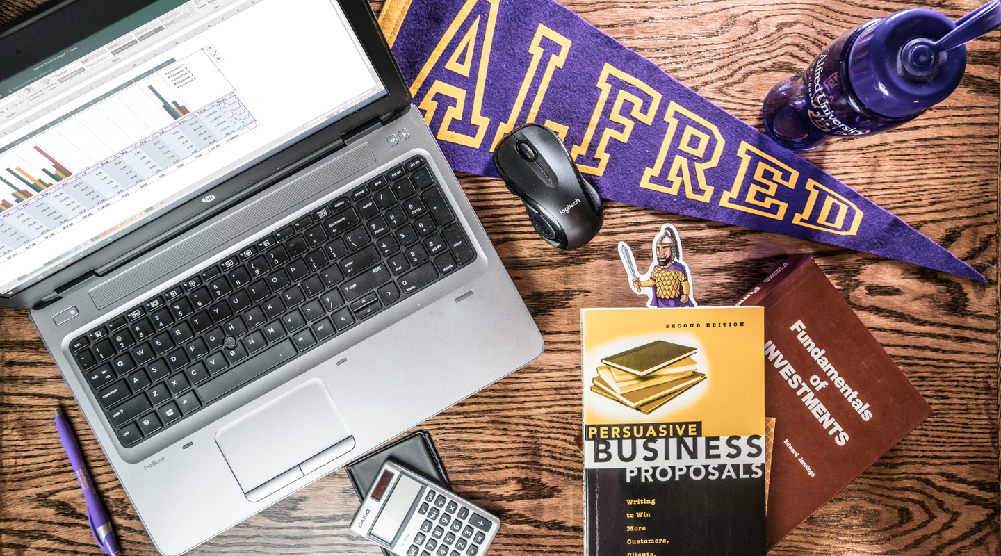 laptop and business books on a desk