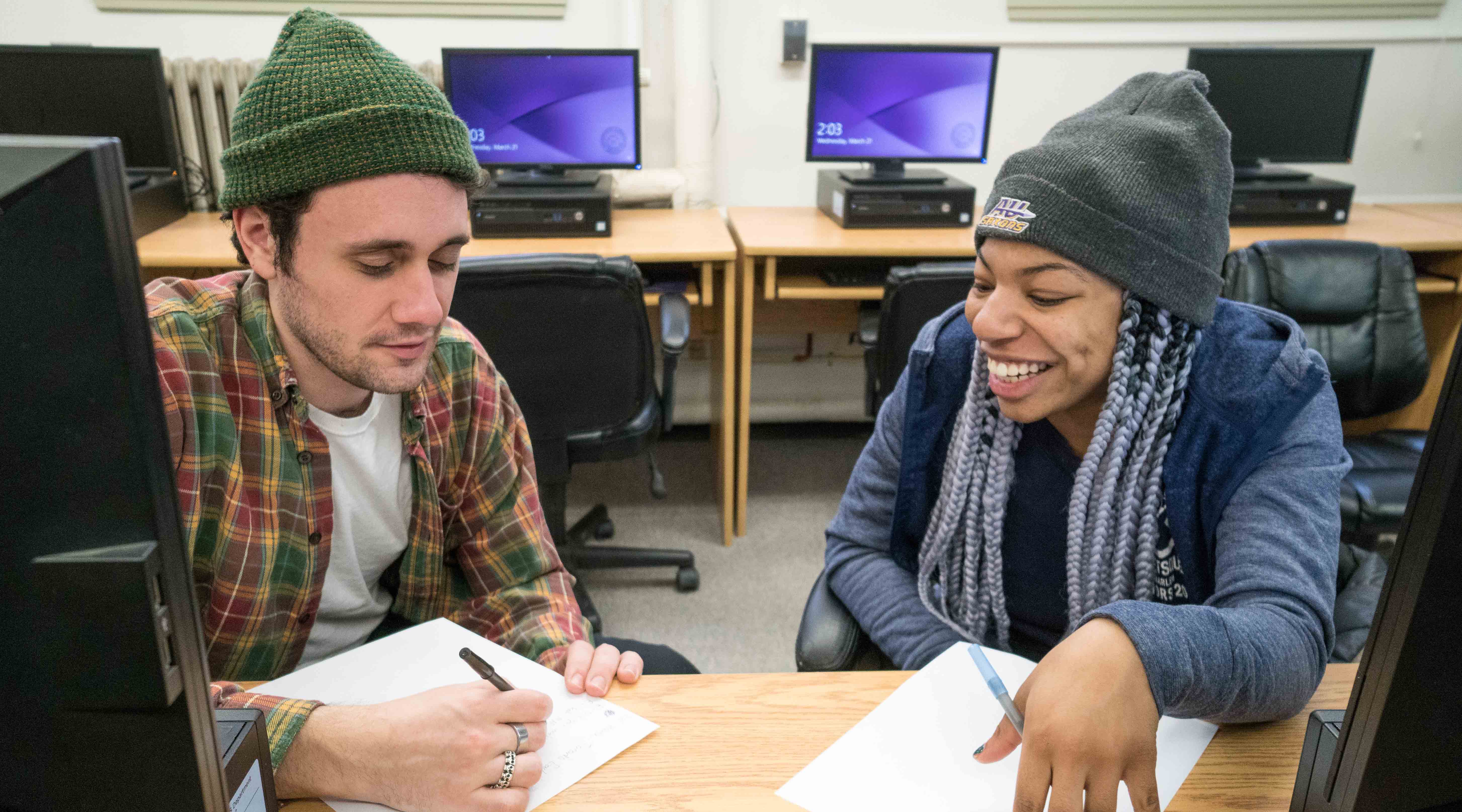 Two students working on a project in a computer lab a c