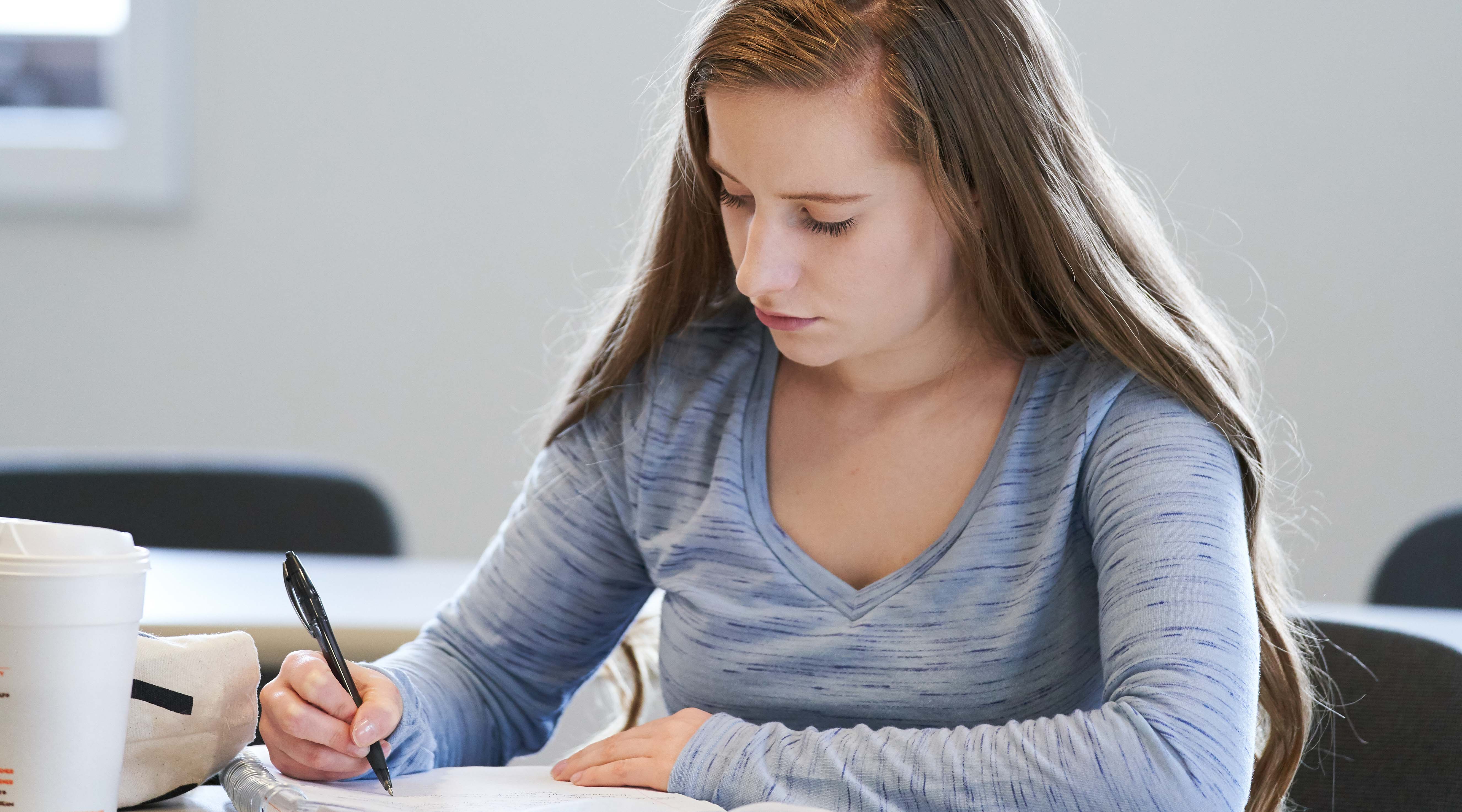 Female student taking notes