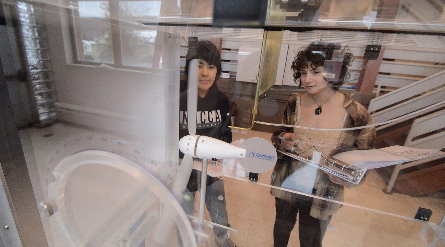 students looking at a machine