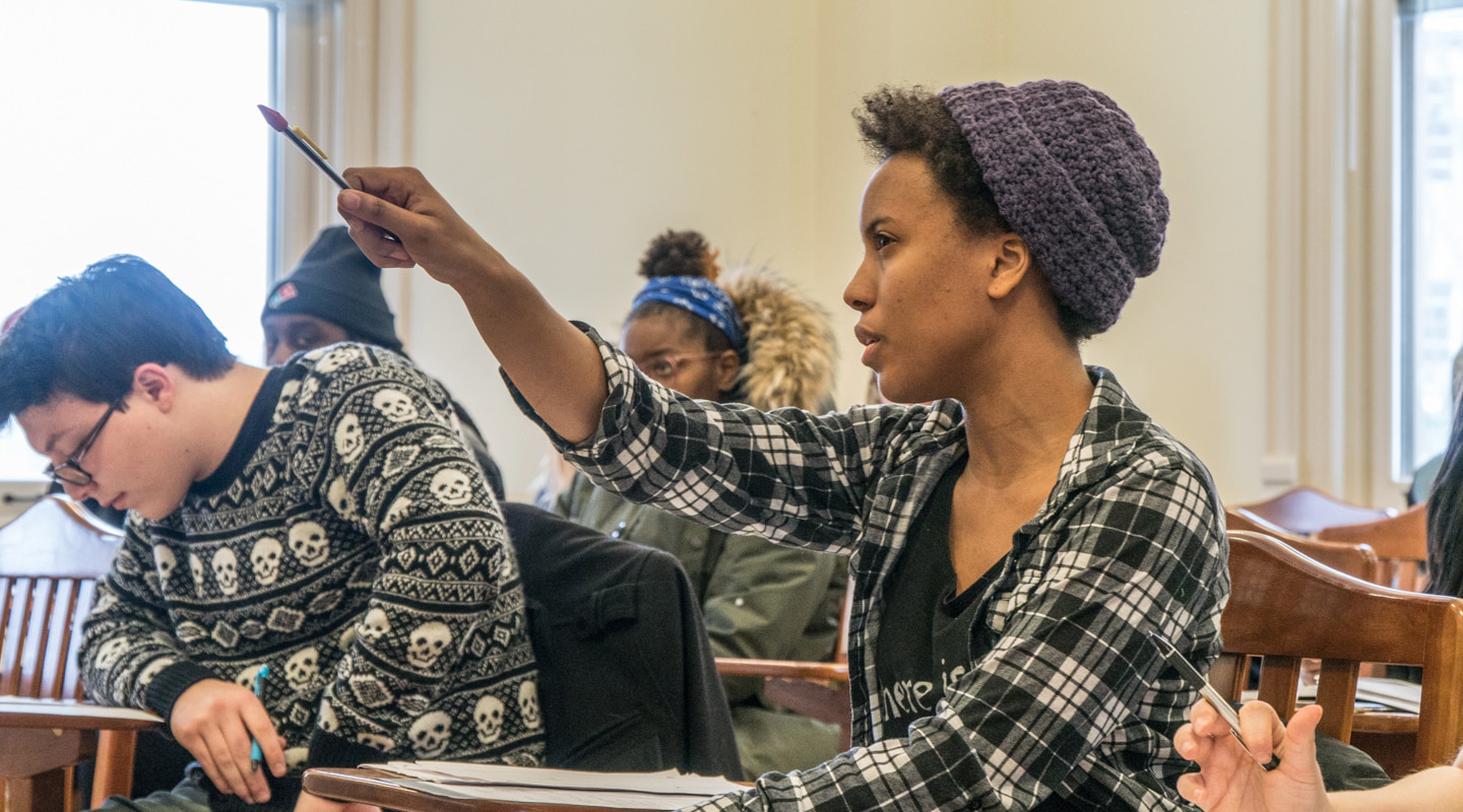 student raising hand in class