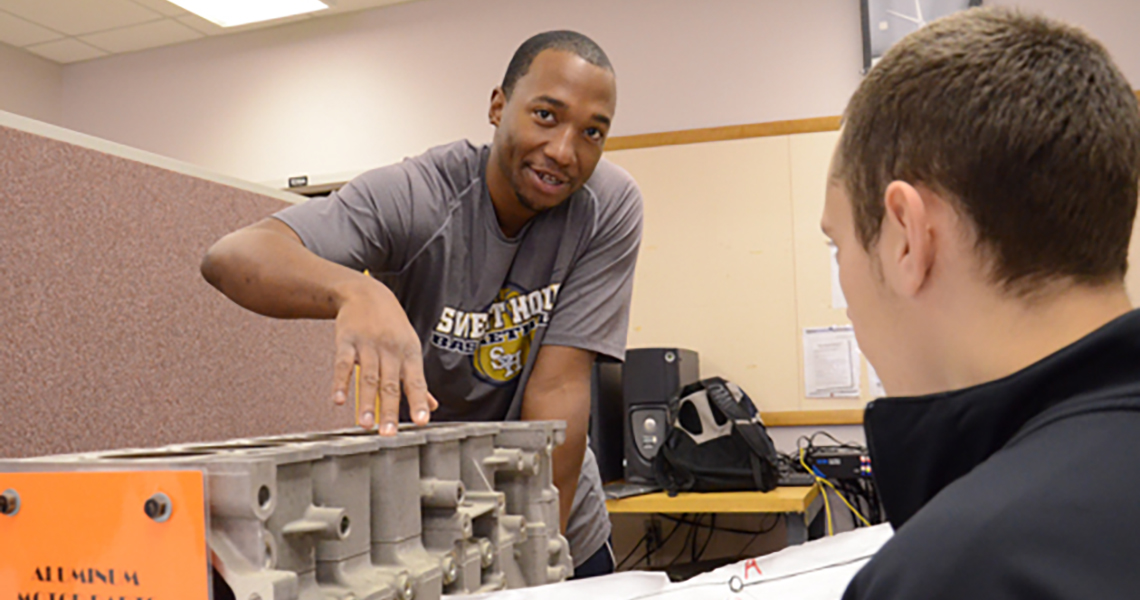 A photo of an Alfred University engineering student working in a lab