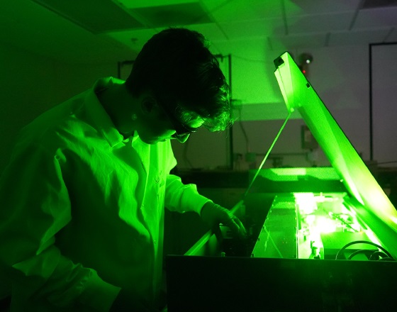 student working with a laser