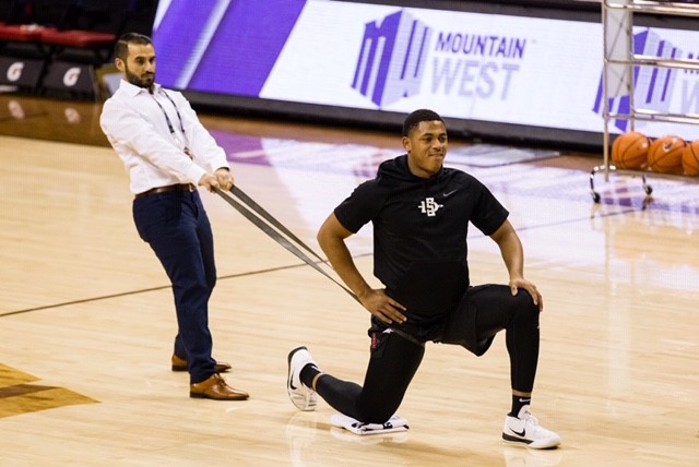 Sergio Ibarra on a basketball court with a player