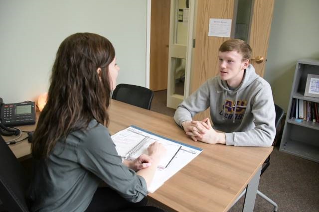 Two students talking at a table