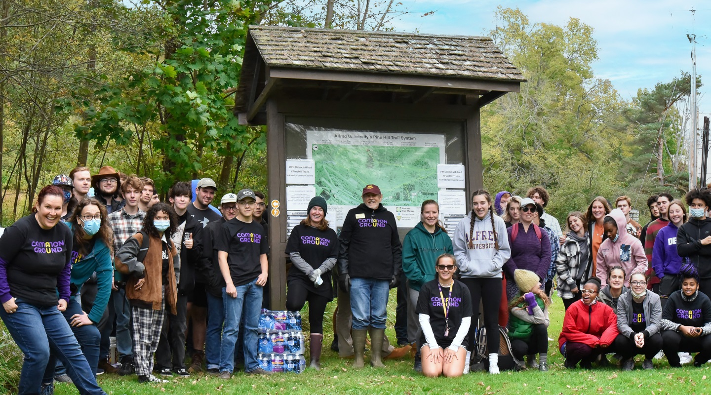 Students standing outside around park sign
