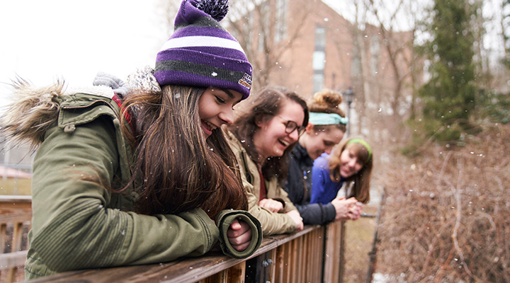students from 2018 laughing together on a bridge