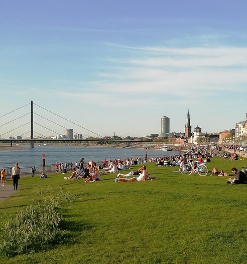 dusseldorf river with artists on its banks