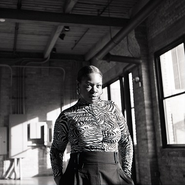 lola ayisha ogbara in black and white in an open warehouse