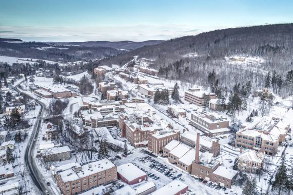 Drone view of Alfred University with snow on covering campus