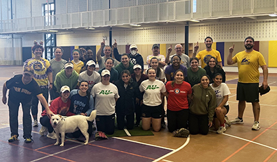 Softball contest between Saxon women's softball team and faculty/staff nets toys for annual toy drive