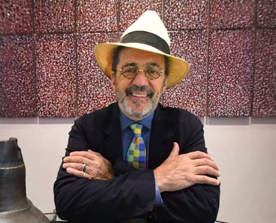 photo of smiling man with glasses and hat