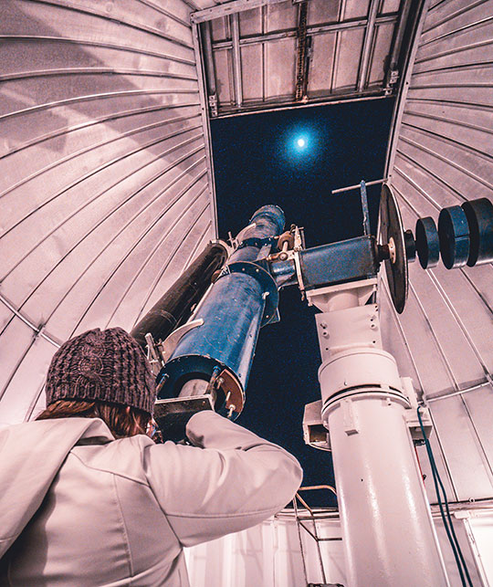person using observatory telescope