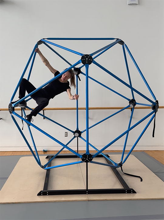 woman climbing inside an icosahedron
