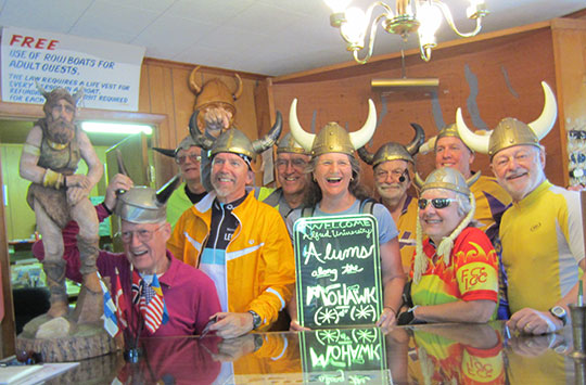 group of people at a bar wearing viking hats