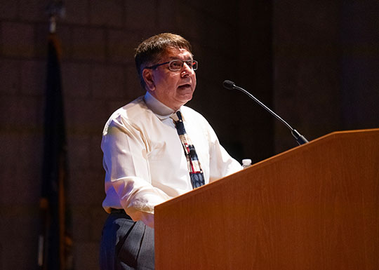 man speaking at a podium