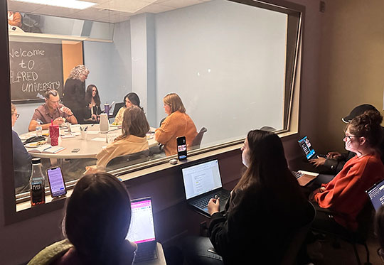 group of people in a room sitting around a table