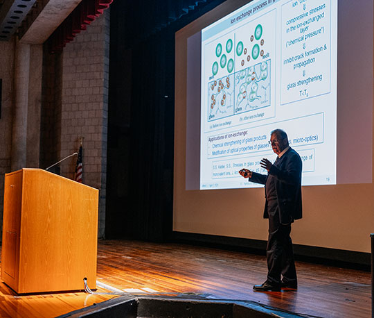 man on stage giving lecture