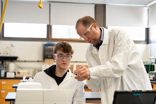 photo of two men conducting lab experiment