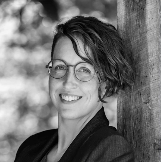 headshot of woman with short hair and glasses