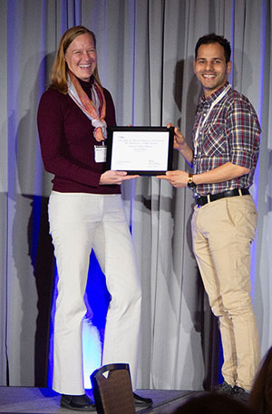 woman handing man a certificate