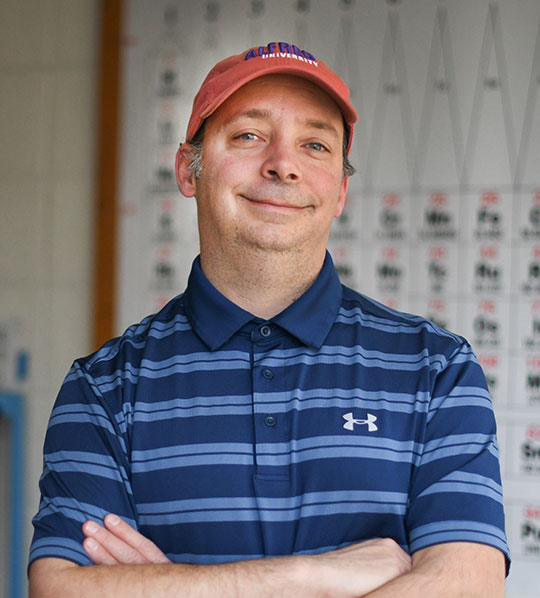 Headshot of a man wearing a hat