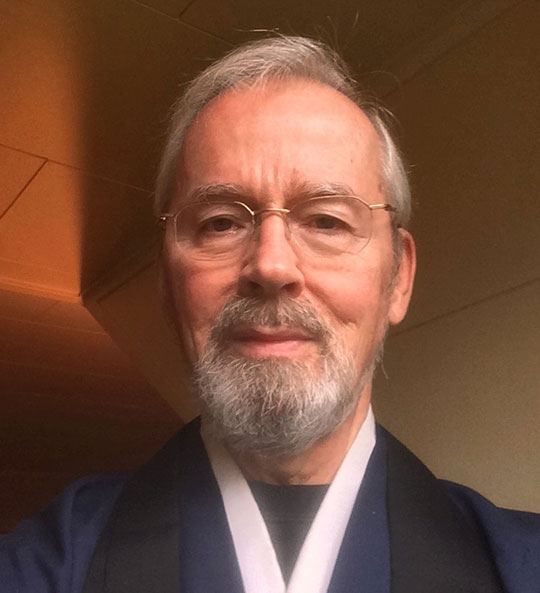 headshot of man with glasses and beard