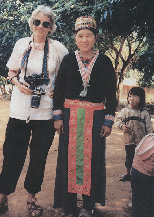 woman holding camera standing next to another woman and a child